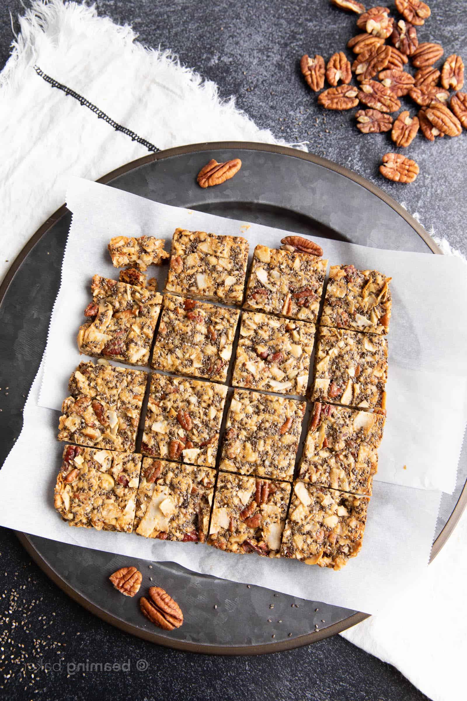 A stack of keto granola bars on parchment paper
