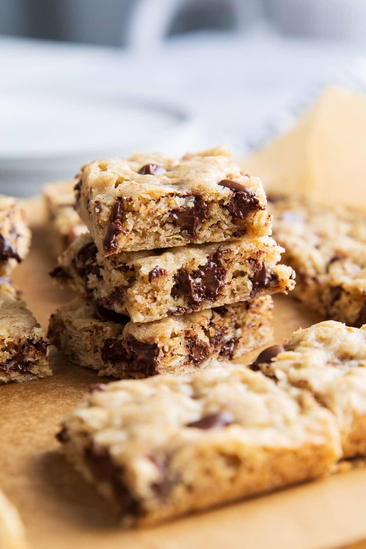 Zähe, feuchte und knusprige Haferflocken-Cookie-Riegel mit Ihren Lieblings-Extras auf Backpapier.